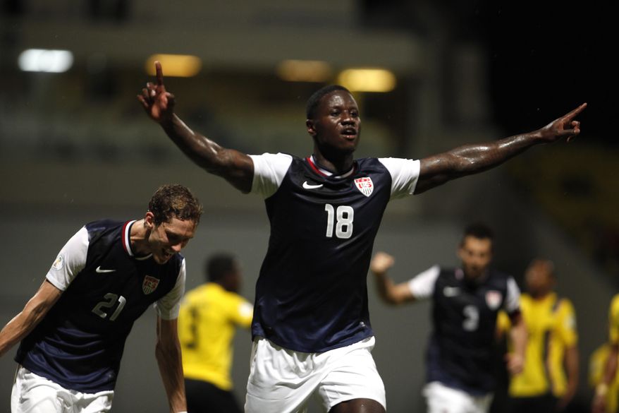 US Eddie Johnson, center, celebrates after scoring against Antigua and Barbuda during a 2014 World Cup qualifying soccer match in St. John, Antigua and Barbuda, Friday, Oct. 12, 2012. (AP Photo/Ricardo Arduengo)