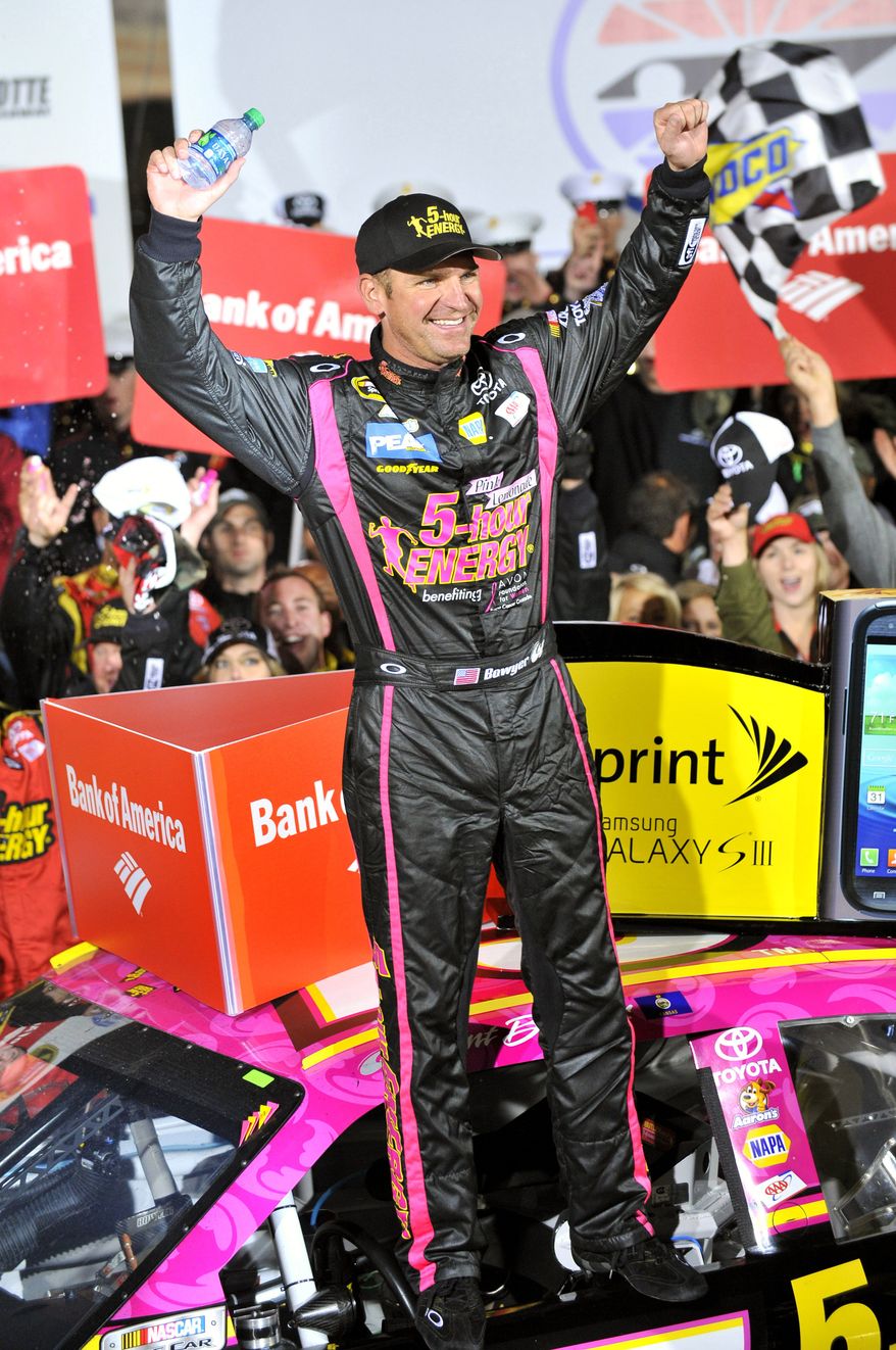 Clint Bowyer celebrates his win in Victory Lane after the NASCAR Sprint Cup Series auto race at Charlotte Motor Speedway, Saturday, Oct. 13, 2012, in Concord, N.C. (AP Photo/Autostock, Nigel Kinrade) MANDATORY CREDIT