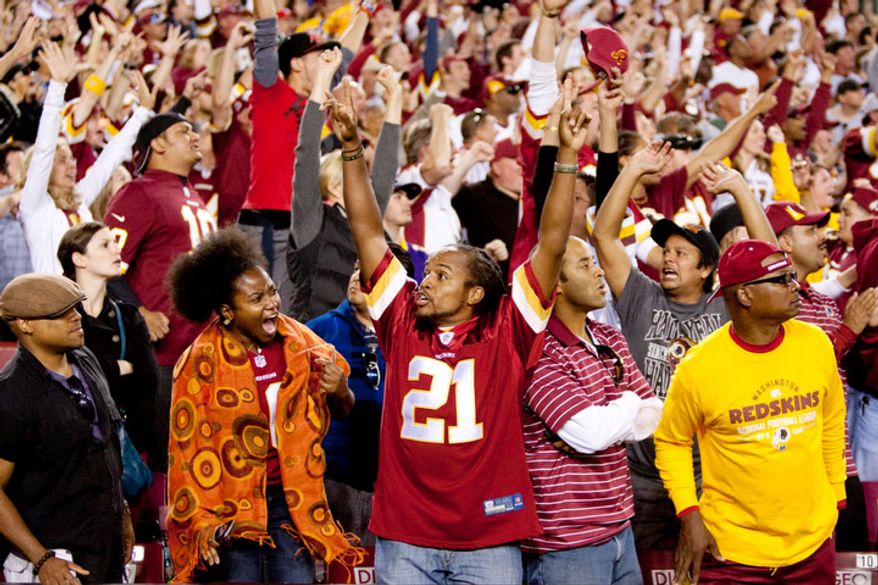 Fans react to Washington Redskins quarterback Robert Griffin III (10) 76 yard touchdown in the forth quarter against the Minnesota Vikings. (Craig Bisacre/The Washington Times)