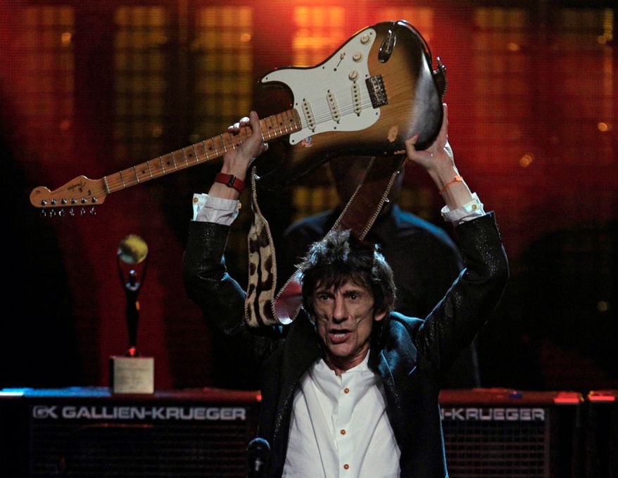 Ronnie Wood celebrates after the finale of the 2012 Rock and Roll Hall of Fame inductions Sunday, April 15, 2012, in Cleveland. The Rolling Stones guitarist was inducted for his earlier work with the Faces. (AP Photo/Tony Dejak)