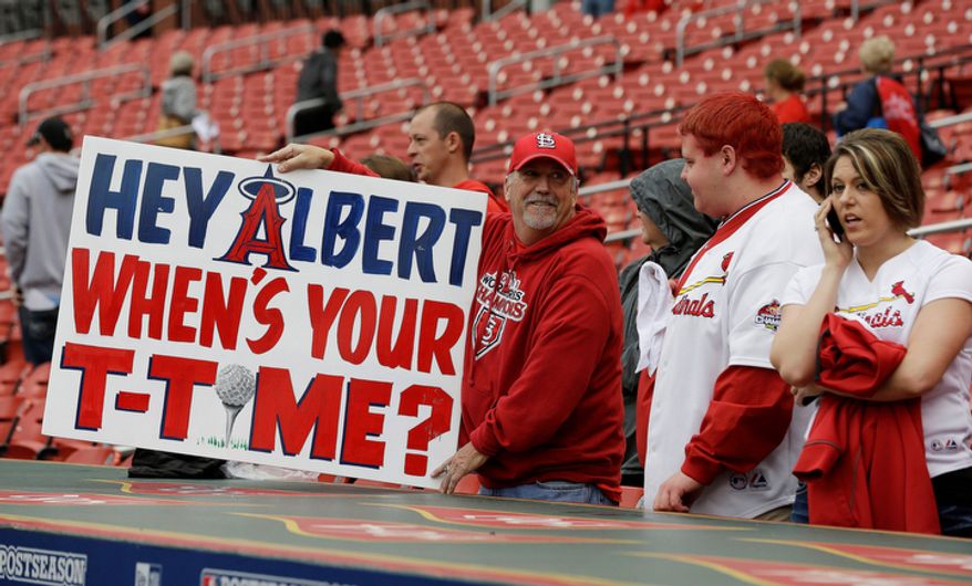 A fan holds up a sign near St. Louis Cardinals dugout before Game 3 of baseball's National League championship series against the San Francisco Giants, Wednesday, Oct. 17, 2012, in St. Louis. (AP Photo/David J. Phillip)