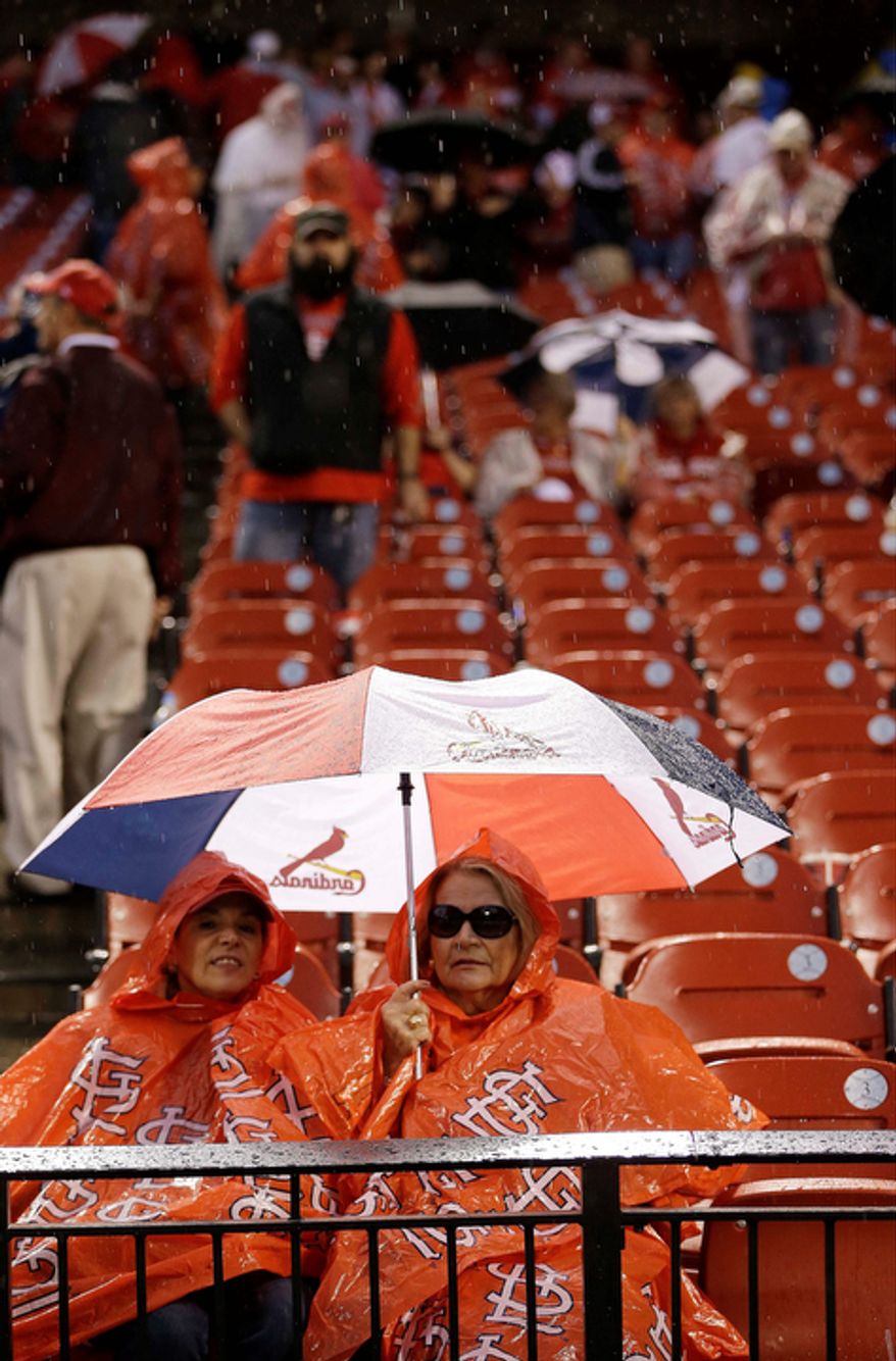 Some fans leave their seats during a rain delay of Game 3 of baseball's National League championship series between the St. Louis Cardinals and the San Francisco Giants, Wednesday, Oct. 17, 2012, in St. Louis. (AP Photo/David J. Phillip)