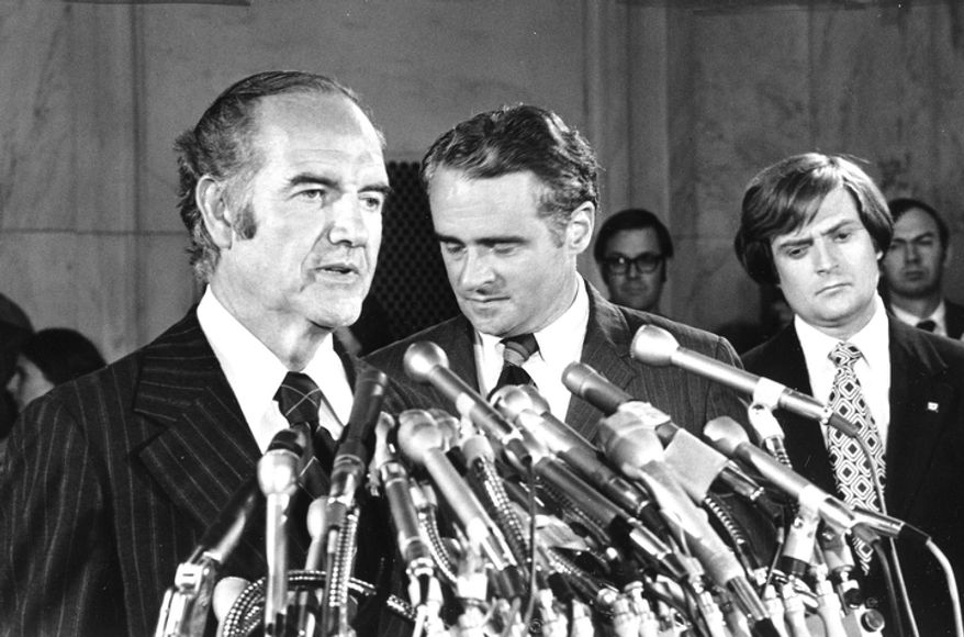 In this photo taken Aug. 1, 1972, Sen. Thomas Eagleton, center rear, has his head down as he listens to presidential hopeful Sen. George McGovern's announcement that Eagleton is stepping aside as vice-presidential running mate, at a Washington news conference. A family spokesman says, McGovern, the Democrat who lost to President Richard Nixon in 1972 in a historic landslide, has died at the age of 90. According to the spokesman, McGovern died Sunday, Oct. 21, 2012 at a hospice in Sioux Falls, surrounded by family and friends. (AP Photo, File)
