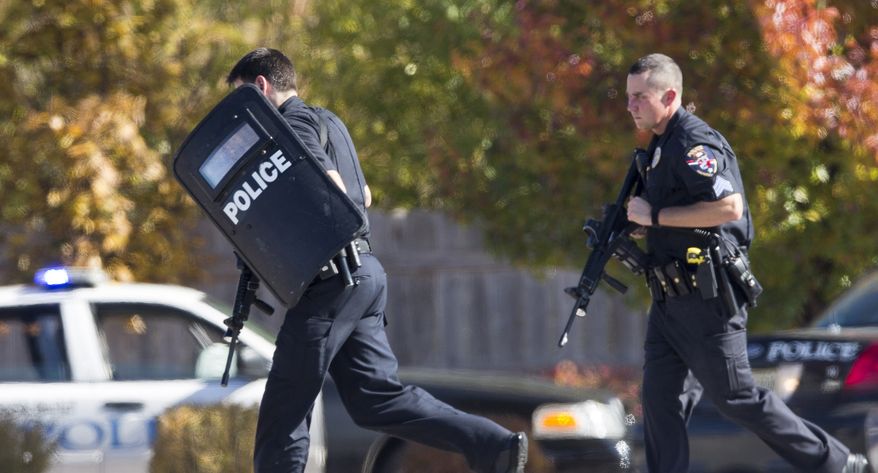 Police respond to a call of a shooting at the Azana Day Spa in Brookfield, Wis., a Milwaukee suburb, on Sunday, Oct. 21, 2012. (AP Photo/Tom Lynn)