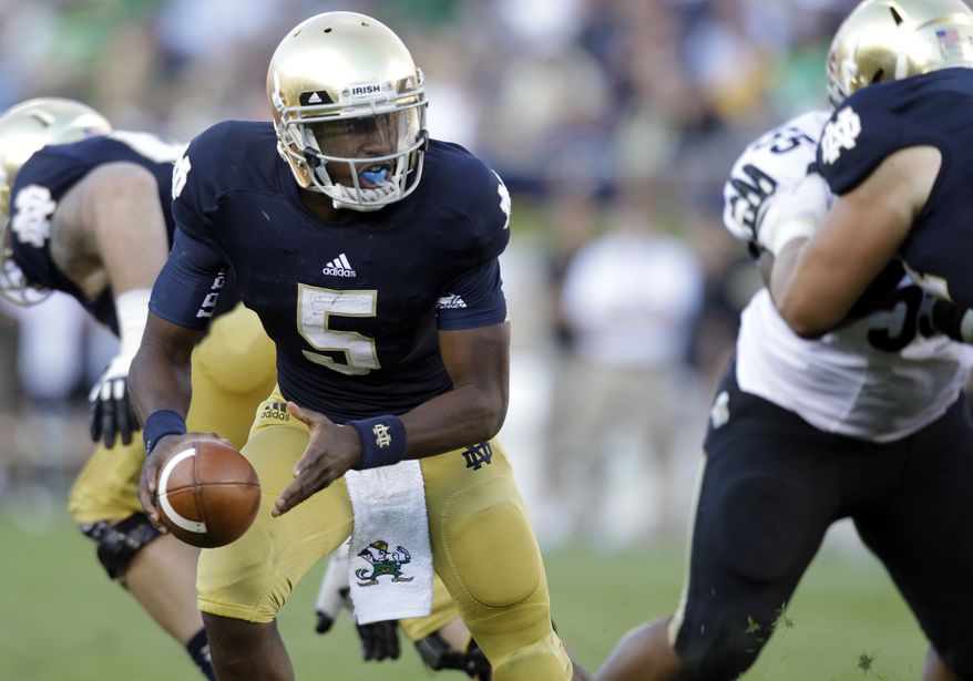 FILE - In this Sept. 8, 2012, file photo, Notre Dame quarterback Everett Golson (5) looks to hand off the ball during the second half of an NCAA college football game against Purdue in South Bend, Ind. Golson didn’t do much last time out to make anyone think he’ll be the quarterback who will lead Notre Dame back to glory, but coach Kelly remains firmly behind him, saying he sees him developing every day in practice. (AP Photo/Michael Conroy, File)