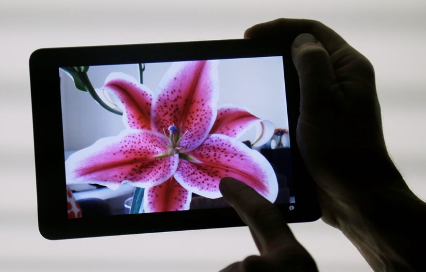 Apple's iPad Mini is shown in San Jose, Calif., on Tuesday, Oct. 23, 2012. The new device has a screen that's about two-thirds the size of the full-size model and will cost $329 and up. (AP Photo/Marcio Jose Sanchez)