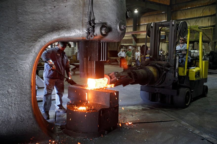 In this Thursday, Sept. 6, 2012, photo, workers form a large spindle at Solmet Technologies in Canton, Ohio. U.S. manufacturing grew for the first time in four months, buoyed by a jump in new orders in September. The increase was a hopeful sign that the economy is improving. The Institute for Supply Management, a trade group of purchasing managers, said on Monday, Oct. 1, 2012, that its index of factory activity rose to 51.5, up from 49.6 in August. (AP Photo/Mark Duncan)