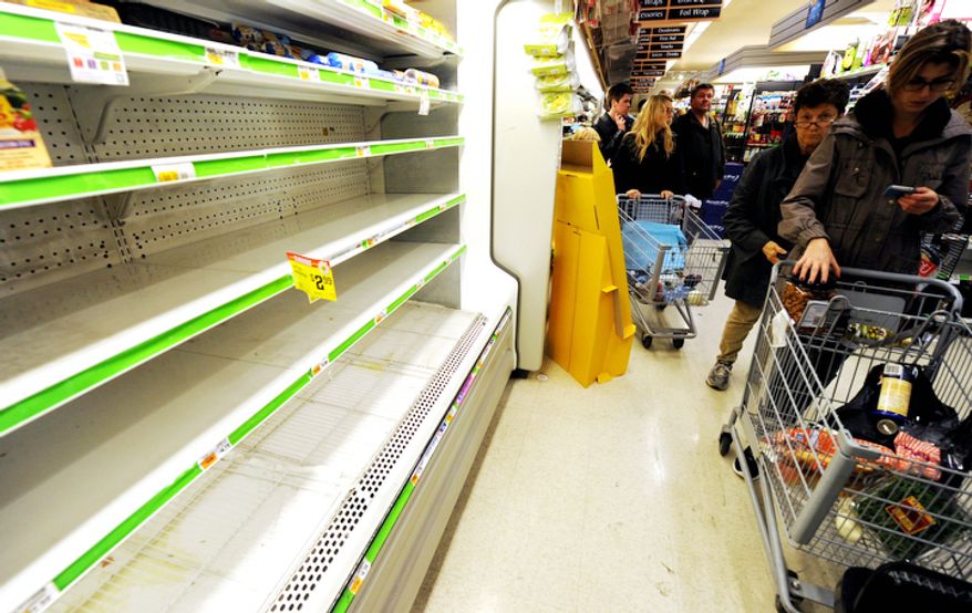 Customers shop for food at a Supermarket in Manhattan. (AP Photo/ Louis Lanzano)