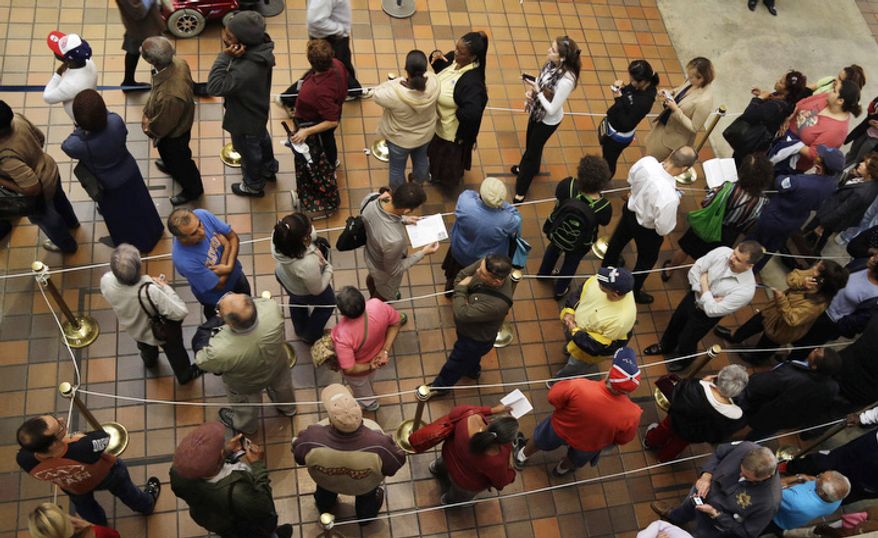 People stand in line to vote during early voting for the presidential election in Miami. About 1.9 million Floridians have already cast ballots eight days before Election Day, Nov 6. (AP Photo/Lynne Sladky)