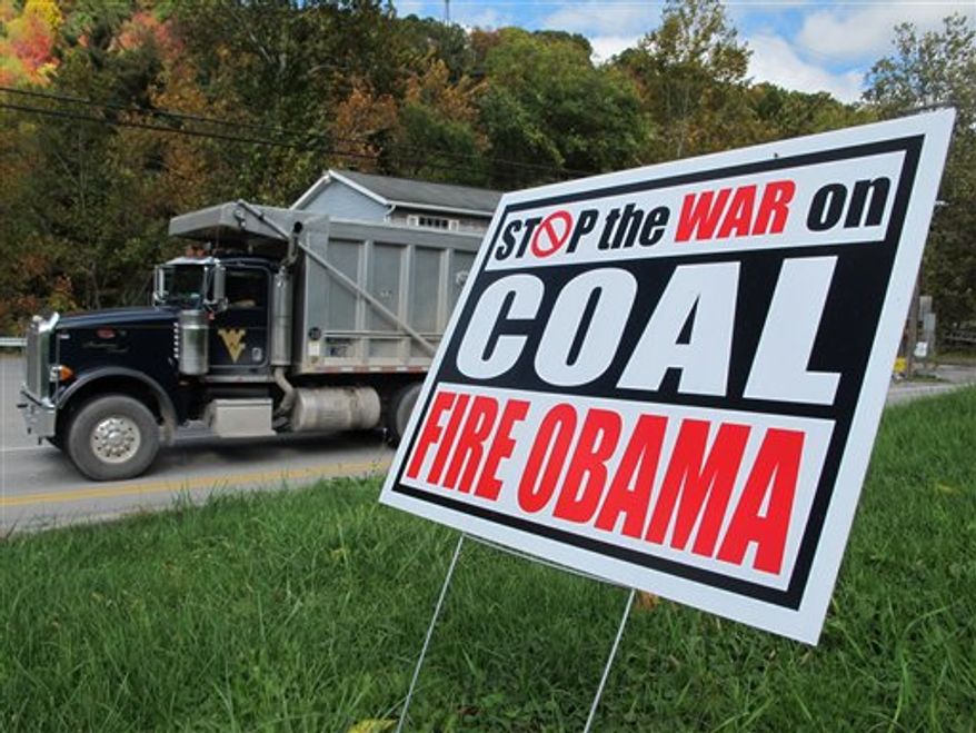 A truck passes a political sign in a yard in Dellslow, W.Va., on Oct. 16, 2012. (AP Photo/Vicki Smith) ** FILE **