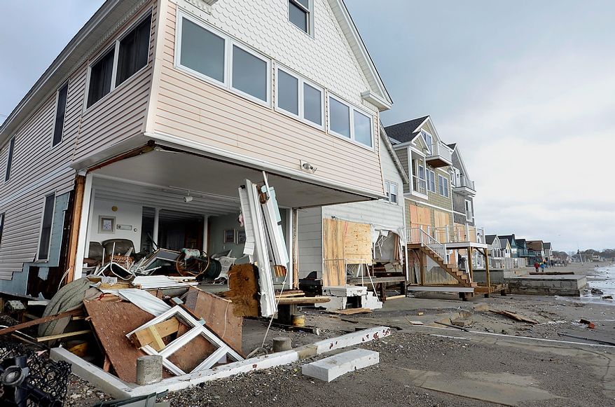 Wreckage lies outsice damaged beach front homes after superstorm Sandy in Milford, Conn., Tuesday, Oct. 30, 2012. (AP Photo/Jessica Hill)