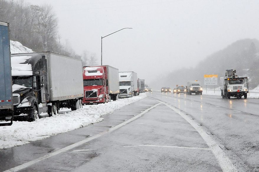 Tractor trailer traffic was halted along Interstate 68 in Frostburg, Md., on Oct. 30, 2012 due to the storm. Wet snow and high winds spinning off the edge of superstorm Sandy spread blizzard conditions over parts of West Virginia and neighboring Appalachian states Tuesday. Authorities closed nearly 50 miles of Interstate 68 on either side of the West Virginia-Maryland state line because of blizzard conditions and stuck cars. Eastbound lanes in Maryland ere later reopened. (AP Photo/Cumberland Times-News, Steven Bittner) WHAG-TV OUT
