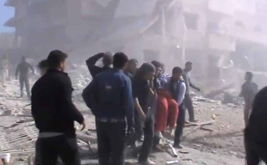 This image taken from video obtained from the Shaam News Network, which has been authenticated based on its contents and other AP reporting, shows attempts to rescue the wounded following heavy bombing from military warplanes in Idlib, in northern Syria, on Monday, Oct. 29, 2012. Syrian warplanes launched 60 airstrikes against rebel targets around the country on Monday, the most intense air raids across the country since the uprising began 19 months ago, according to anti-regime activists. At least 500 people were killed over the four-day period ending Monday when a U.N.-backed truce was supposed to be in effect, activists said, and the death toll for Monday so far has reached 80. (AP Photo/Shaam News Network via AP video)