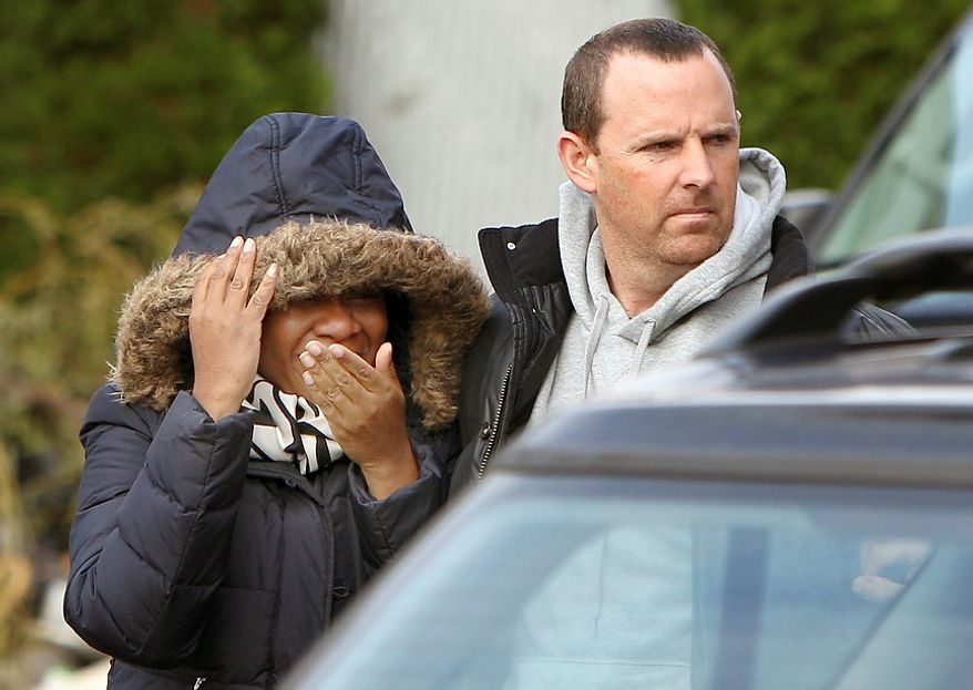Glenda Moore, and her husband, Damian Moore, react as they approach the scene where at least one of their childrens' bodies were discovered in Staten Island, New York, Thursday, Nov. 1, 2012. Brandon Moore, 2, and Connor Moore, 4, were swiped into swirling waters as their mother tried to escape her SUV on Monday amid rushing waters that caused the vehicle to stall during Superstorm Sandy. Police said the mother, Glenda Moore, was going to her sister's home in Brooklyn when she tried to flee the vehicle with the boys, only to have the force of the rising water and the relentless cadence of pounding waves rip the boy's small arms from her. (AP Photo/Seth Wenig)