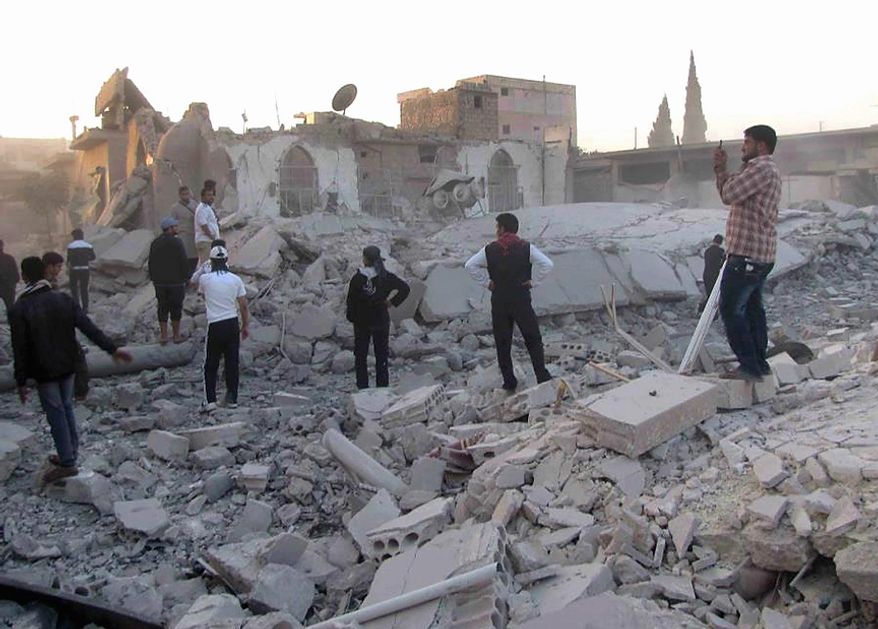 In this picture taken on Thursday November 1, 2012 citizen journalism image, provided by Edlib News Network, ENN, which has been authenticated based on its contents and other AP reporting, Syrians inspect a mosque which was destroyed in shelling by Syrian forces loyal to Syrian President Bashar Assad, in the village of Taftanaz, Idlib province, northern Syria. Syrian rebels killed more than 75 soldiers on Thursday, about half of them in attacks on military checkpoints in the north just hours after a wave of bombings hit the Damascus area, activists said. The unusually high toll for regime forces came after days of intense air bombardment of rebel positions around the country that killed hundreds. (AP Photo/Idlib News Network ENN)