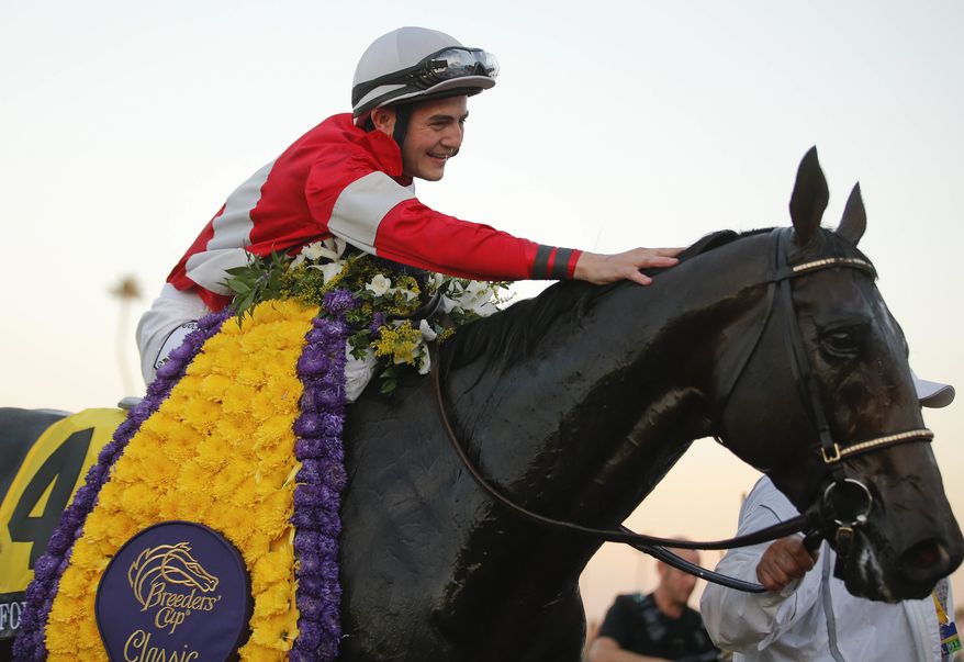 Brian Hernandez Jr. pats Fort Larned on the neck after winning the running of the Breeders' Cup Classic horse race, Saturday, Nov. 3, 2012, at Santa Anita Park in Arcadia, Calif. (AP Photo/Jae C. Hong)