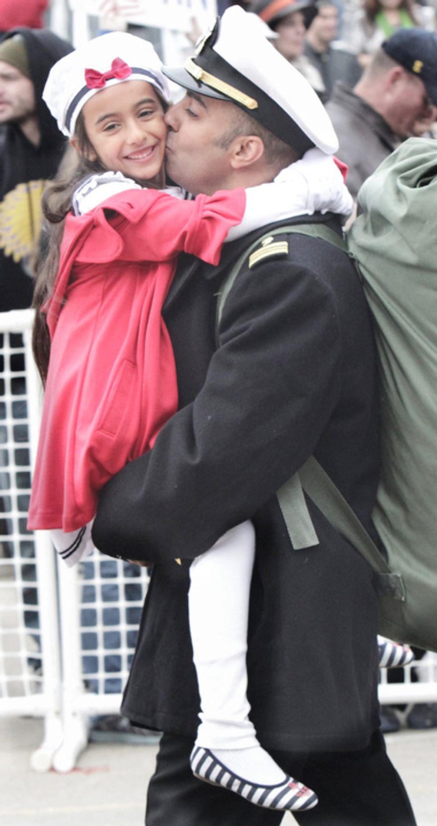 Balhar Purewal kisses her father Lt. Cmdr. Amarjeet Purewal as the USS Enterprise, the world's first nuclear-powered aircraft carrier, returns to Norfolk Naval Station in Norfolk, Va., on Sunday, Nov. 5, 2012. The 51-year-old ship completed its 25th and final deployment where thousands of cheering family members and friends welcomed the ship home from its 25th and final deployment after nearly eight months at sea. (AP Photo/The Virginian-Pilot, Steve Earley)