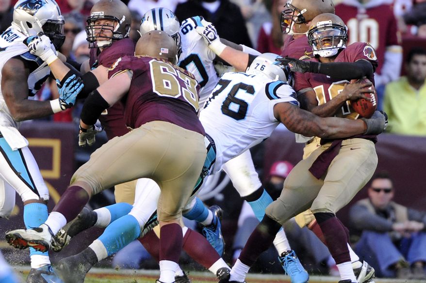 Washington Redskins quarterback Robert Griffin III (10) is sacked by Carolina Panthers defensive end Greg Hardy (76) in the fourth quarter at FedEx Field, Landover, Md., Nov. 4, 2012. (Preston Keres/Special to The Washington Times)