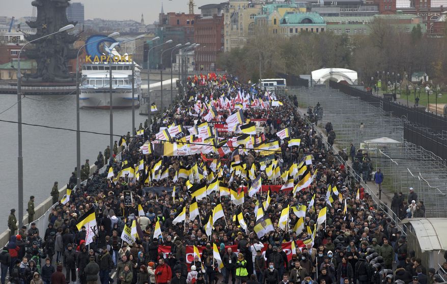 Ultranationalist demonstrators and activists march carrying the Russian Empire's black, yellow and white flag to mark National Unity Day, on the outskirts of Moscow on Sunday, Nov. 4, 2012. (AP Photo/Ivan Sekretarev)