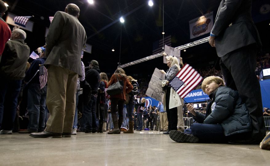 A child sits on the floor during republican presidential candidate, former Massachusetts Gov. Mitt Romney campaign rally at The Patriot Center, George Mason University in Fairfax, Va., Monday, Nov. 5, 2012. (Craig Bisacre/The Washington Times)