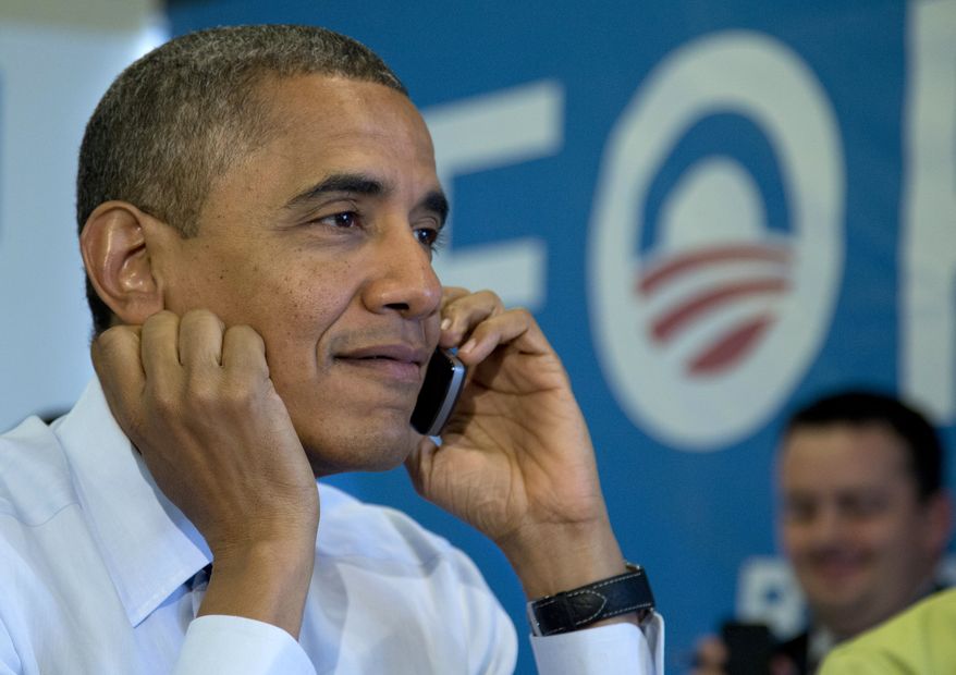 President Obama calls Wisconsin volunteers while visiting a campaign office call center in Chicago on Nov. 6, 2012, the morning of the 2012 election. (Associated Press)