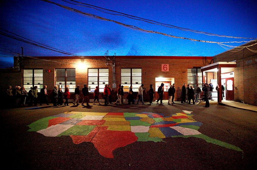 Voters make their way into the polling station at Washington Mill Elementary School in Alexandria, Va., on Nov. 6, 2012, just after the station opened at 6 a.m. (Eva Russo/Special to The Washington Times)
