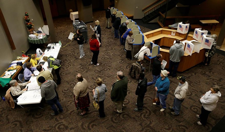 Voters in Precinct 39 wait in line for their ballots before casting their vote on Election Day, Tuesday, Nov. 6, 2012, at the First Church of the Open Bible in Des Moines, Iowa. (AP Photo/Charlie Neibergall)
