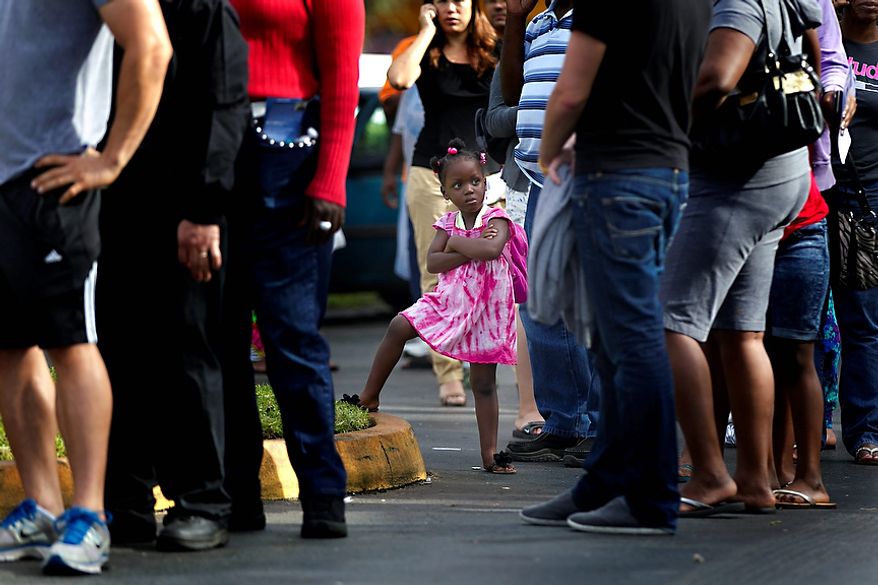 Kezia Gipson, 3, waits with her grandparents Doris Ross and Freddie Irvin in a voting line at the International Longshoreman's Association Office in Ft. Lauderdale, Fla.Tuesday, Nov. 6, 2012. After a grinding presidential campaign President Barack Obama and Republican presidential candidate, former Massachusetts Gov. Mitt Romney, yield center stage to American voters Tuesday for an Election Day choice that will frame the contours of government and the nation for years to come. (AP Photo/The Miami Herald,Joe Rimkus Jr. ) MAGS OUT