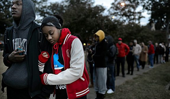 William Wright, left, and India Johnson, right, both freshman at ODU, wait on line to vote at Larchmont Elementary School in Norfolk, Va. on Tuesday, Nov. 6, 2012. Wright and Johnson, both 18 and from Richmond, were excited to cast their first votes in the Presidential election. (AP Photo/The Virginian-Pilot, Amanda Lucier)