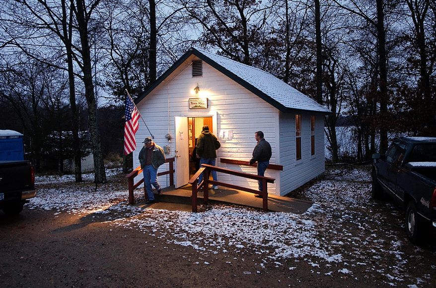A light wet snow covers the roof and ground around the Jenkins Town Hall as early voters casts their ballots Tuesday, Nov. 6, 2012 in Jenkins, Minn. Jenkins is located in Crow Wing County in northern Minnesota. (AP Photo/Tom Olmscheid)