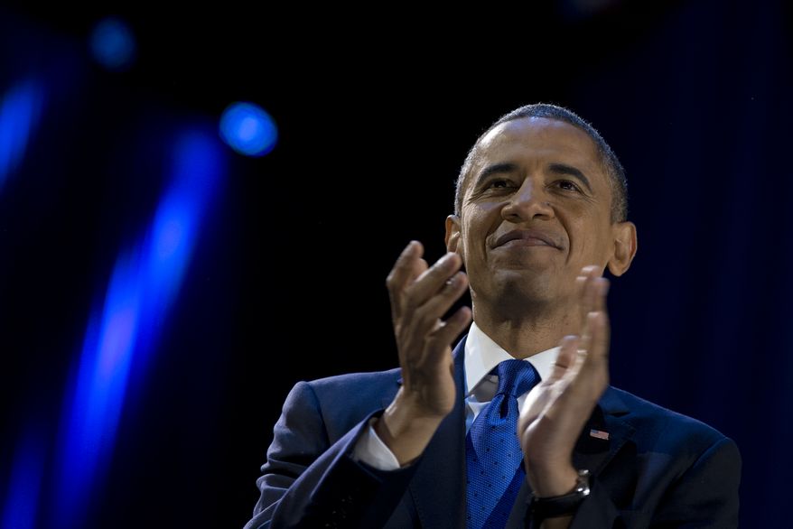 President Obama pauses as he speaks to the cheering crowd at his election-night victory party at McCormick Place in Chicago on Wednesday, Nov. 7, 2012. (AP Photo/Carolyn Kaster)