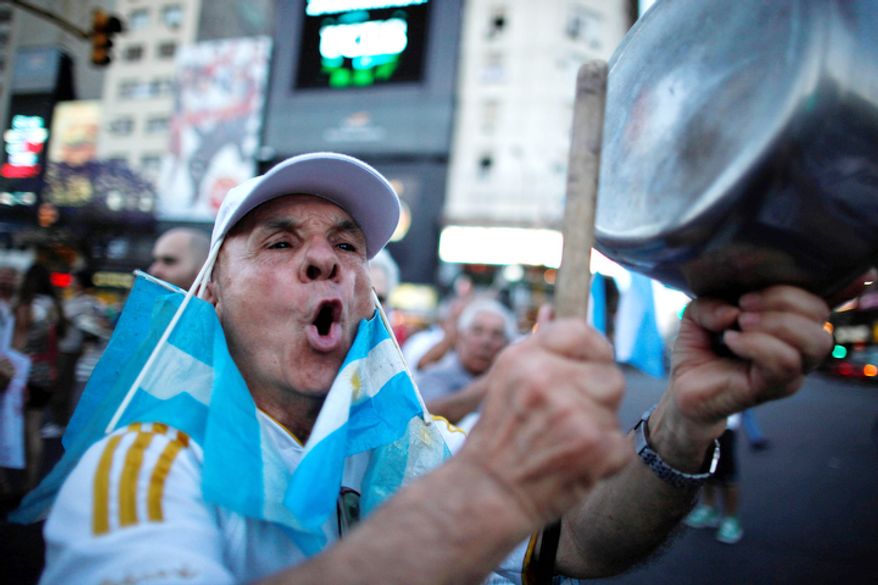 ** FILE ** A protester bangs a pot during a march against Argentina's President Cristina Fernandez in Buenos Aires, Argentina. (AP Photo/Natacha Pisarenko)