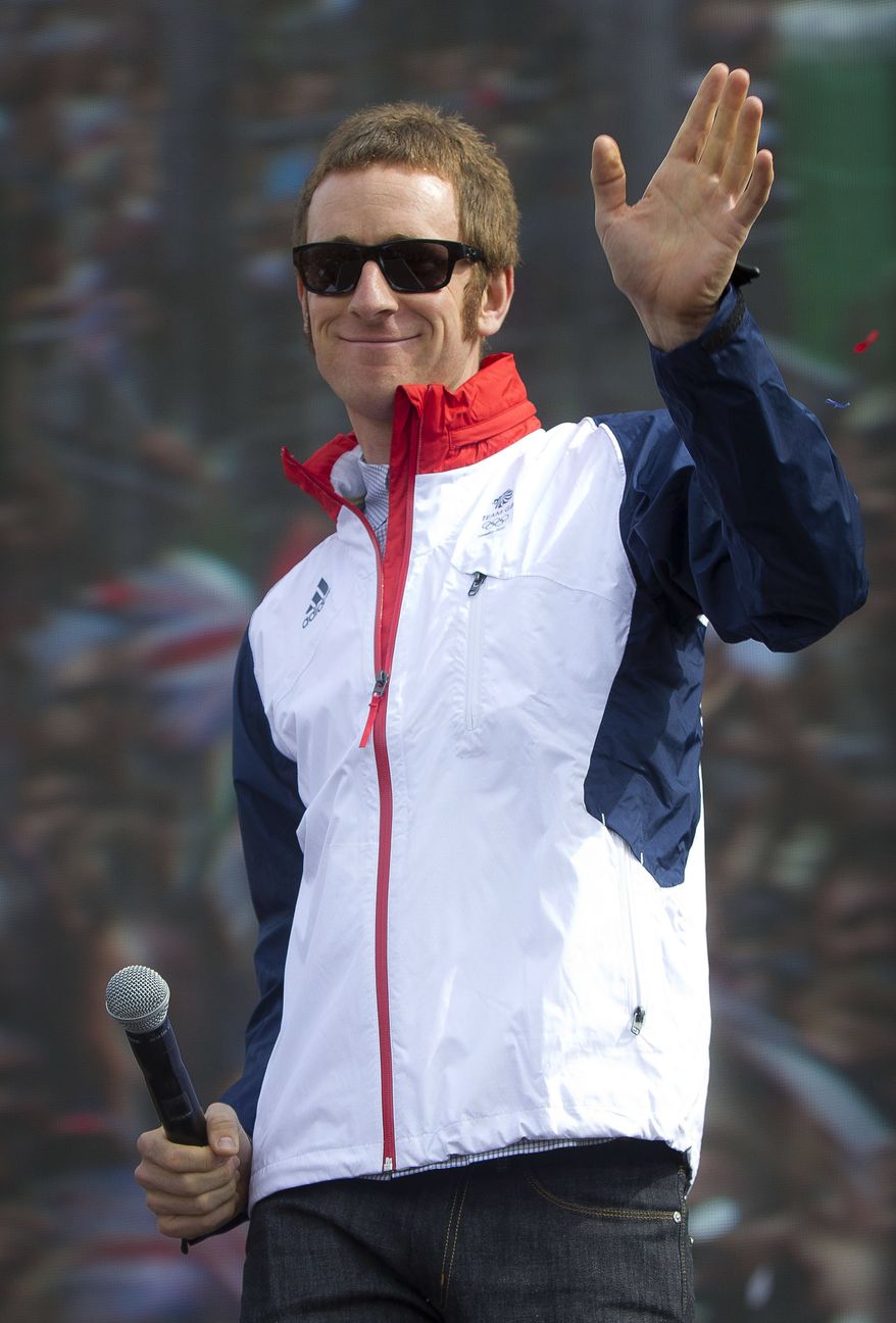 FILE - In this Saturday, Aug. 4, 2012 file photo, British cyclist Bradley Wiggins greets fans on stage for BT London Live concert at Hyde Park in central London. Tour de France champion Bradley Wiggins was recovering in hospital Wednesday, Nov. 7, 2012, after being hit by a car while riding his bike in northern England. Team Sky said Wiggins will be kept in the hospital overnight for observation, but that "the injuries he sustained are not thought to be serious and he is expected to make a full and speedy recovery." (AP Photo/Joel Ryan, File)