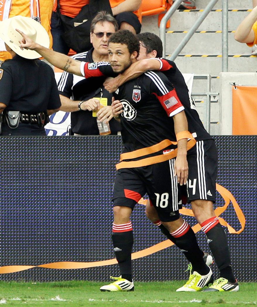 D.C. United's Nick DeLeon (18) celebrates his goal with Lewis Neal, right, during the first half of an MLS Eastern Conference Championship soccer game against the Houston Dynamo, Sunday, Nov. 11, 2012, in Houston. (AP Photo/David J. Phillip)
