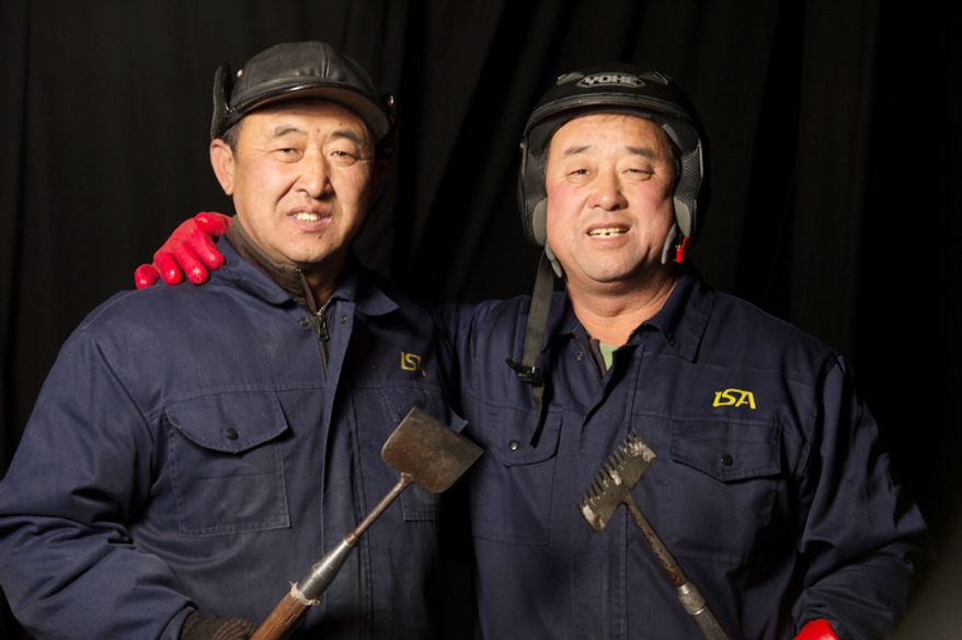 Sun Wen Quan, 57, (left) and his brother Sun Wen Xue, 55, (right) are two of the 40 artisan ice sculptors from Harbin, China, working on the construction of the attraction ICE! These sculptors are master carvers who spend a month here each year turning two million pounds of ice into colorful ice sculptures in an environment of nine degrees. They are from Harbin, China, the capital city of China's northernmost province, Heilongjiang, across the border from Siberia, Russia. . (Rod Lamkey Jr./The Washington Times)