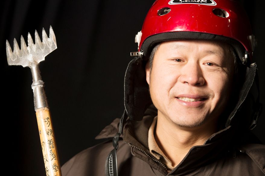 Yin Guo Long, 50, is one of the 40 artisan ice sculptors from Harbin, China, working on the construction of the attraction ICE! featuring DreamWorks Shrek the Halls at the Gaylord National Resort & Convention Center in National Harbor, Md., Friday, Nov. 9, 2012. They are from Harbin, China, the capital city of China's northernmost province, Heilongjiang, across the border from Siberia, Russia. Harbin, China has been host of the Ice and Snow Festival for more than 25 years, welcoming approximately 800,000 visitors annually. (Rod Lamkey Jr./The Washington Times)