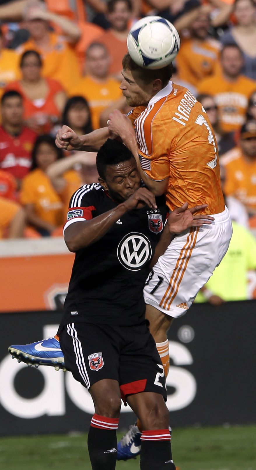 D.C. United's Lionard Pajoy, left, collides with Houston Dynamo's Andre Hainault (31) during the first half of an MLS Eastern Conference Championship soccer game, Sunday, Nov. 11, 2012, in Houston. (AP Photo/David J. Phillip)