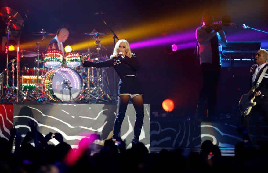 Gwen Stefani, center, performs with her band No Doubt during the 2012 MTV European Music Awards show at the Festhalle in Frankfurt, central Germany, Sunday, Nov. 11, 2012. (AP Photo/Michael Probst)