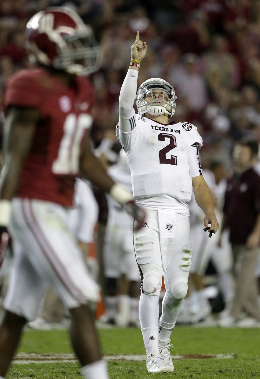 Texas A&M quarterback Johnny Manziel (2) reacts during the second half of his team's 29-24 win against No. 1 Alabama in Tuscaloosa, Ala., on Nov. 10, 2012. At left is Alabama defensive back John Fulton. (Associated Press)