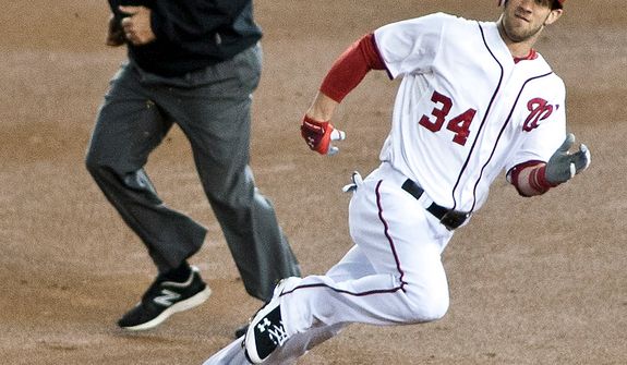 Washington Nationals center fielder Bryce Harper (34) rounds second before safely siding into third in the first inning in Game 5 of the National League Division Series between the Washington Nationals and the St. Louis Cardinals at Nationals Park, Thursday, October 11, 2012. (Craig Bisacre/The Washington Times)