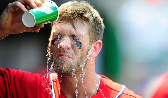 Bryce Harper splashes water on his face in between innings during the Nationals game against the Colorado Rockies at Nationals Park, Washington D.C., Sunday, July 8, 2012. Game time temperature at the park was 95 degrees Fahrenheit. (Ryan M.L. Young/The Washington Times)