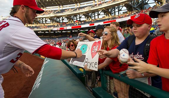 Bryce Harper signs autographs before the Washington Nationals take on the Arizona Diamondbacks in Major League Baseball at Nations Ballpark, Washington, D.C., Tuesday, May 1, 2012. (Andrew Harnik/The Washington Times)