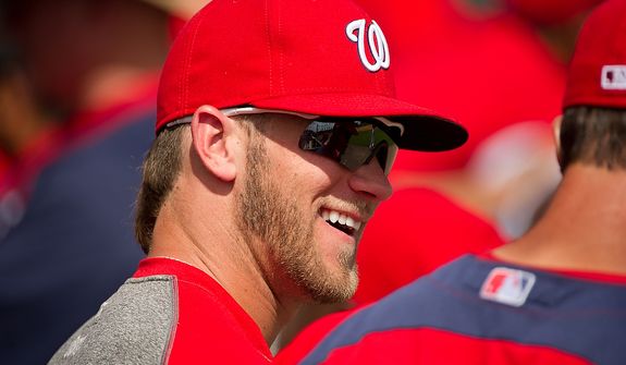 Washington Nationals right fielder Bryce Harper (34) shares a laugh with a teammate as the Washington Nationals plays the Georgetown Hoyas during spring training exhibition game at Space Coast Stadium, Viera, Fla., Friday, March 2, 2012. (Andrew Harnik/The Washington Times)