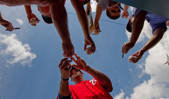 Washington Nationals right fielder Bryce Harper (34) signs autographs for fans before the Washington Nationals play the Houston Astros during spring training at the Osceola County Stadium, Kissimmee, Fla., Saturday, March 3, 2012. (Andrew Harnik/The Washington Times)