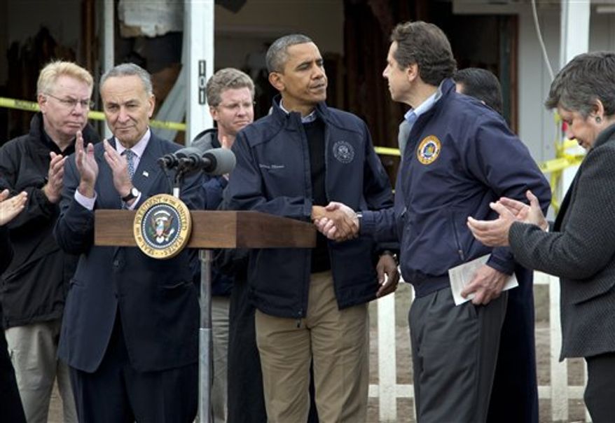 President Obama shakes hands with New York Gov. Andrew Cuomo, during a news conference on Cedar Grove Avenue, a street significantly impacted by Superstorm Sandy, on Staten Island, Thursday, Nov. 15, 2012, in New York. Sen. Charles Schumer, New York Democrat, is second from left, Secretary of Housing and Urban Development Shaun Donovan is third from left, and Secretary of Homeland Security Janet Napolitano is right. (AP Photo/Carolyn Kaster)