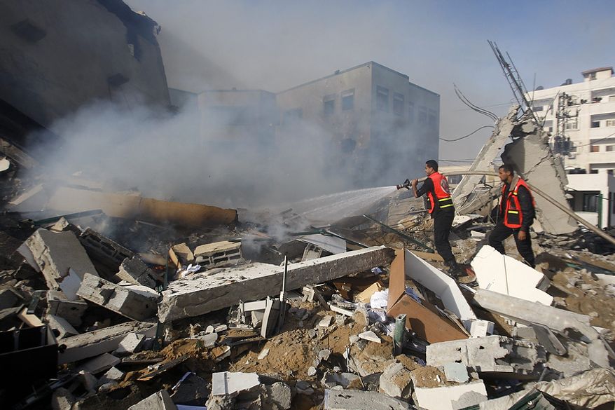 Palestinian firefighters try to extinguish a fire after an Israeli air strike on the building of Hamas' Ministry of Interior in Gaza City, Friday, Nov. 16, 2012. (AP Photo/Hatem Moussa)