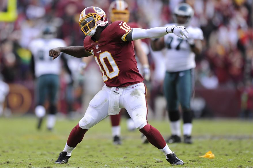Washington Redskins quarterback Robert Griffin III (10) celebrates his 61-yard touchdown pass to wide receiver Santana Moss in the third quarter at FedEx Field, Landover, Md., Nov. 18, 2012. (Preston Keres/Special to The Washington Times)