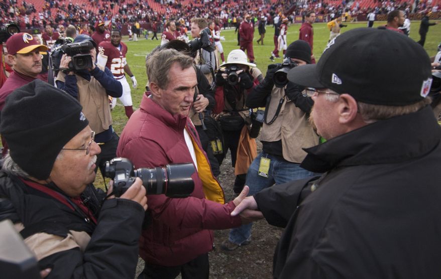 Washington Redskins head coach Mike Shanahan shacks hands with Philadelphia Eagles head coach Andy Reid after winning 31 to 3, Landover, Md., Sunday, November 18, 2012. (Craig Bisacre/The Washington Times)
