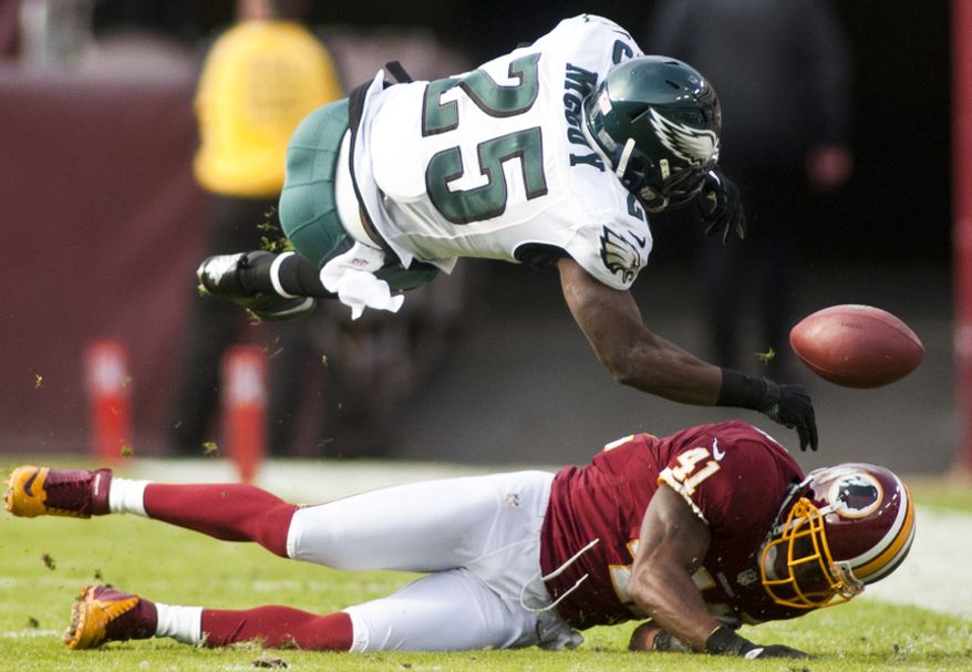 Washington Redskins free safety Madieu Williams (41) hits Philadelphia Eagles running back LeSean McCoy (25) in the second quarter forcing a fumble, Landover, Md., Sunday, November 18, 2012. (Craig Bisacre/The Washington Times)
