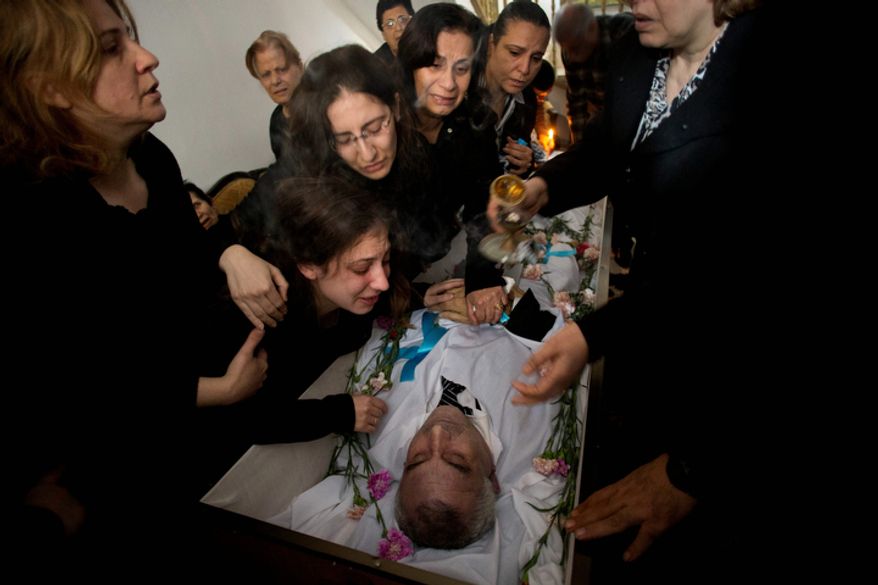 Palestinians mourners cry during the funeral of Salem Paul Sweliem in Gaza City on Nov. 20, 2012. According to the family, the 52-year-old Greek Orthodox Christian carpenter was killed during an Israel Air Force strike on a high-rise building, in which Ramez Harb, a senior figure in Islamic Jihad's military wing, was killed. Sweliem was in car when the strike took place and died on his way to the hospital from shrapnel wounds. (Associated Press)